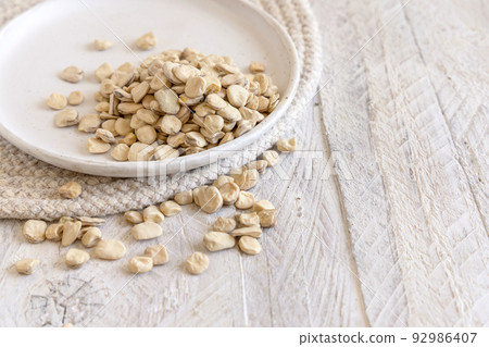 Plate of raw dry Grass pea close up on wooden table. Legumes known in Italy as Cicerchia 92986407