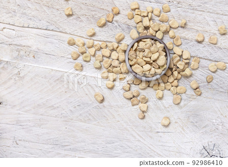 Bowl of raw dry Grass pea on wooden table top view. Legumes known in Italy as Cicerchia Bowl of raw dry Grass pea on wooden table top view. Legumes known in Italy as Cicerchia 92986410