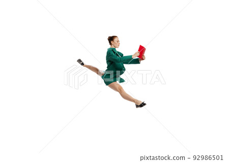 Leap. Stylish young woman in business style outfit in motion isolated over white background. Emotions, finance, aspiration, business, job concept. 92986501