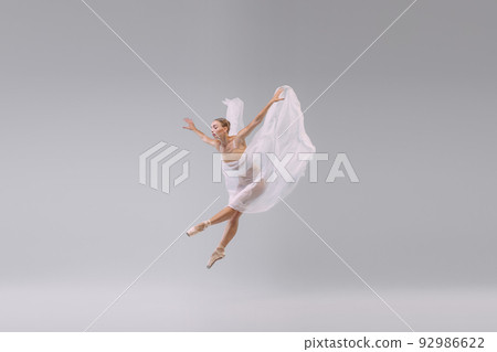 Portrait of young ballerina dancing with fabric isolated over grey studio background. The grace, artist, movement Portrait of young ballerina dancing with fabric isolated over grey studio background. The grace, artist, movement 92986622