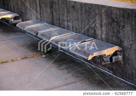An old and rust abandoned metallic bench in the city An old and rust abandoned metallic bench in the city 92988777