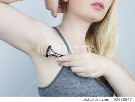 Armpit rash. Underarm skin irritation. Blonde girl shows irritation on the skin after using a razor, trimmer, deodorant or antiperspirant. Allergy or irritation. Acne or red spots Armpit rash. Underarm skin irritation. Blonde girl shows irritation on the skin after using a razor, trimmer, deodorant or antiperspirant. Allergy or irritation. Acne or red spots 92988847