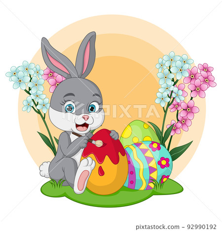 Cute little bunny painting an easter eggs in the grass Cute little bunny painting an easter eggs in the grass 92990192