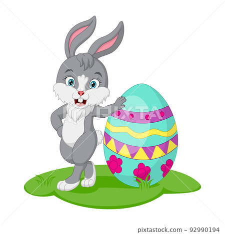 Cute little bunny with easter egg in the grass 92990194