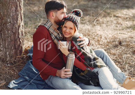 Couple by the tree. People in a spring forest. Pair with thermos. 92990721