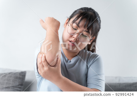Closeup female's elbow. Arm pain and injury. Health care and medical concept. 92991424