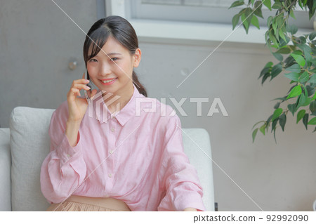 Bird's eye view _ Woman sitting on the sofa and calling 3 92992090