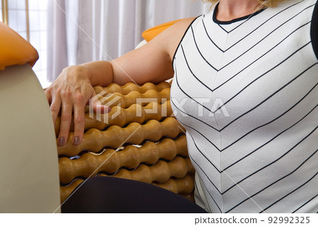 woman making massage for hand. Roll Massage machine is a way to shape the figure. Skin Care, body care concept. modern relax massage equipment. woman making massage for hand. Roll Massage machine is a way to shape the figure. Skin Care, body care concept. modern relax massage equipment. 92992325