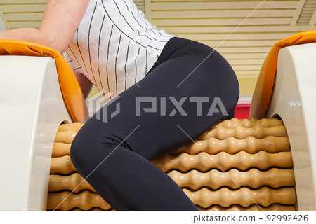 smiling woman making massage for back. Roll Massage machine is a way to  shape the figure. Skin Care, body care concept modern relax massage  equipment Stock Photo - Alamy