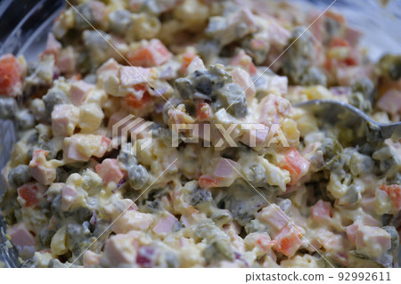 Traditional Russian Olivier salad of boiled sausage pickled green peas, eggs and mayonnaise Traditional Russian Olivier salad of boiled sausage pickled green peas, eggs and mayonnaise 92992611