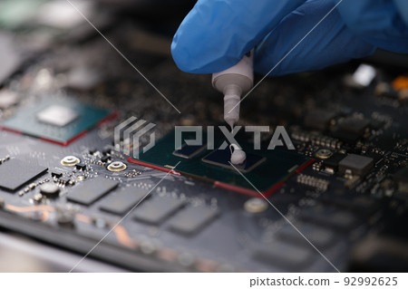 Thermal paste on computer processor chip closeup Thermal paste on computer processor chip closeup 92992625