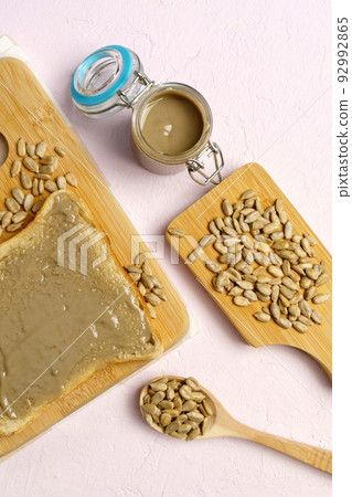 Organic toast bread with healthy organic sunflower seed butter close up. Vertical photo 92992865