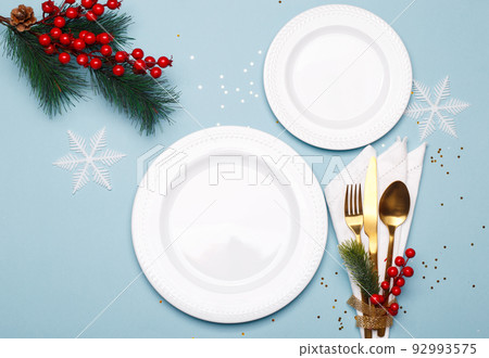 Christmas or new year table setting with golden cutlery Christmas or new year table setting with golden cutlery 92993575