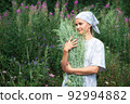 Village girl with bouquet of wormwood. Artemisia absinthium 92994882