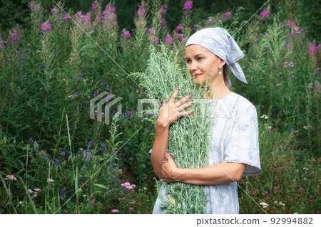 Village girl with bouquet of wormwood. Artemisia absinthium 92994882