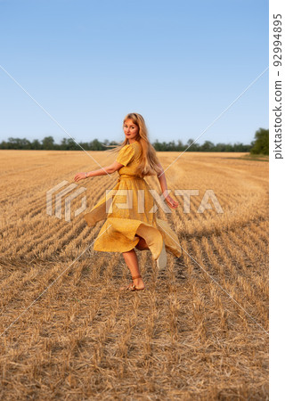 Cute girl posing on the background of a wheat field Cute girl posing on the background of a wheat field 92994895