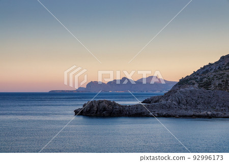 A view of the east coast of the island of Rhodes at sunset. 92996173