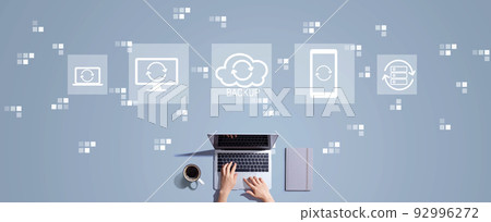 Backup concept with person working with laptop Backup concept with person working with laptop 92996272