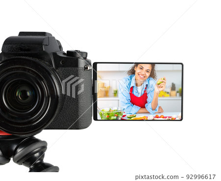 Vlogger woman chef records a video of cooking recipe 92996617