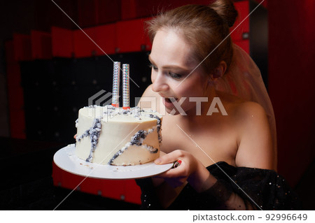 indoor portrait beautiful woman holding birthday cake. 92996649