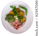 Potato pancakes with bacon on white plate 92997090