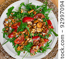Salad with arugula and chanterelle mushrooms on plate 92997094