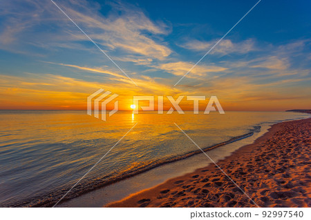 Beautiful summer sunset over beach at Baltic sea Beautiful summer sunset over beach at Baltic sea 92997540