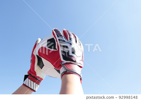 Goalkeeper man catching a soccer ball 92998148