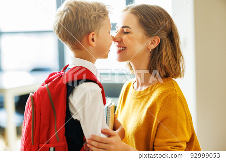 Mother preparing son for school studies 92999053
