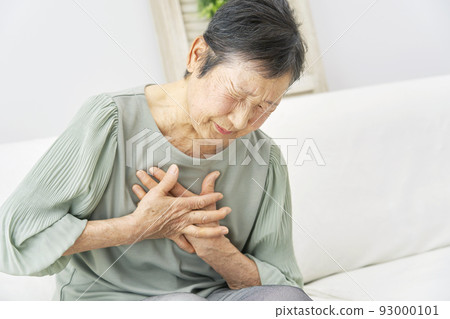 Senior woman feeling palpitations at home Senior woman feeling palpitations at home 93000101