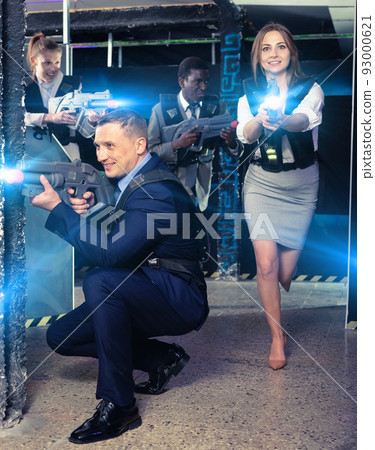 Men and women in business suits playing laser tag emotionally in Men and women in business suits playing laser tag emotionally in 93000621