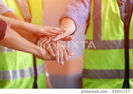 Team engineering and foreman connect joining hands together, Stack of hands. Team engineering and foreman connect joining hands together, Stack of hands. 93001757