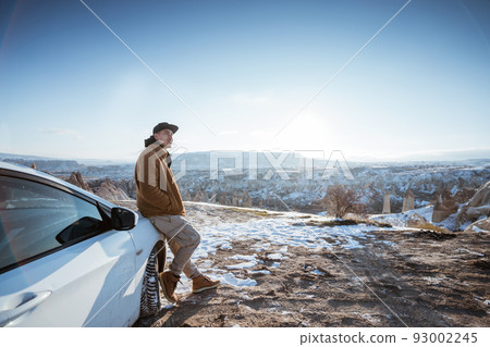 man on his adventure going to beautiful hill in cappadocia by his car man on his adventure going to beautiful hill in cappadocia by his car 93002245