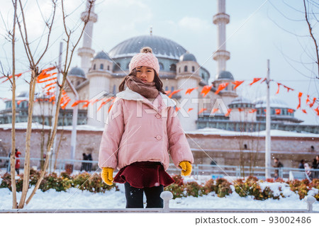 girl looking at the camera with mosque in the background 93002486