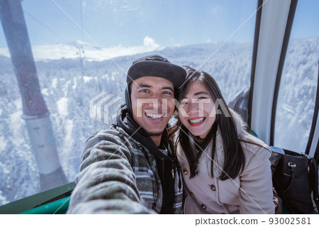 couple riding a cable car in the beautiful snowy mountain in turkey couple riding a cable car in the beautiful snowy mountain in turkey 93002581