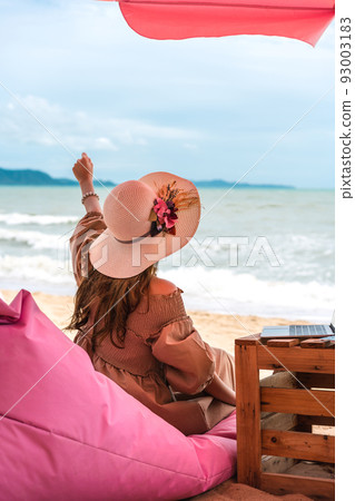 Young adult asian blogger woman relax on the beach. 93003183