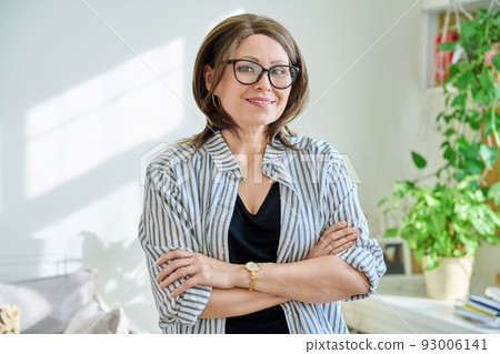 Portrait of confident mature woman looking at camera at home Portrait of confident mature woman looking at camera at home 93006141