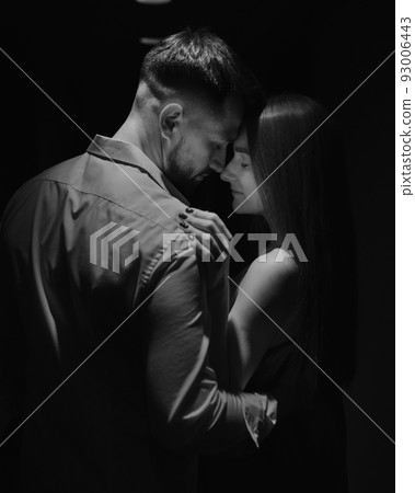Portrait of couple in love standing face to face in the corridor of the hotel 93006443
