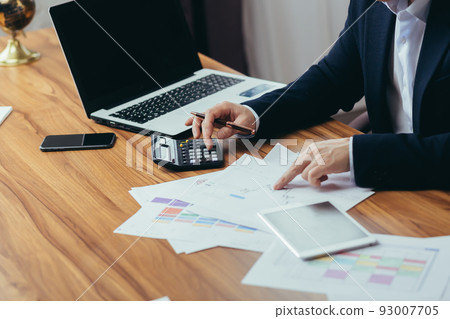 Close-up photo, businessman accountant's hand counts on a calculator, man sitting at a table paperwork Close-up photo, businessman accountant's hand counts on a calculator, man sitting at a table paperwork 93007705