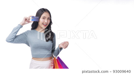 Excited asian showing credit card holding shopping bags in arm standing white background. Cheerful Excited asian showing credit card holding shopping bags in arm standing white background. Cheerful 93009640