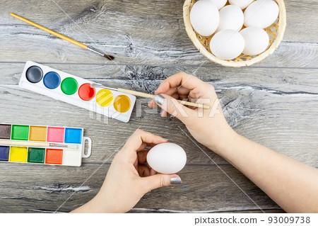 Girl paints eggs Girl paints eggs 93009738