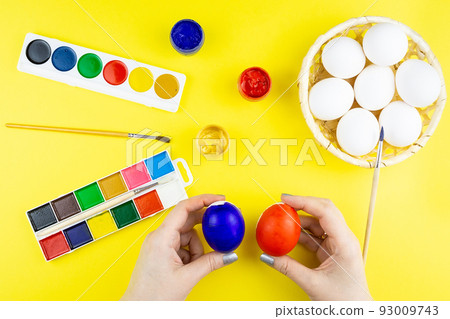 Girl paints eggs Girl paints eggs 93009743