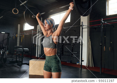 Athletic Sport Girl with Perfect Fitness Body Doing Workout Hard Training with Bar Athletic Sport Girl with Perfect Fitness Body Doing Workout Hard Training with Bar 93011197