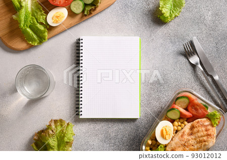 Weight loss concept, calories counting, diet, food control and calorie counter, diet plan. Notebook, food, salad, egg , water and vegetable. 93012012