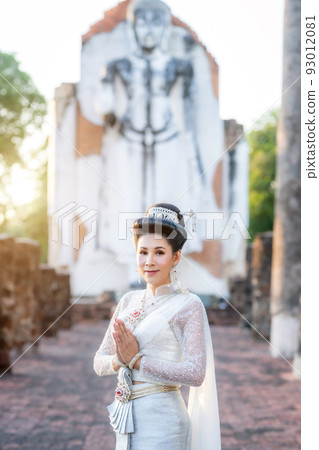 Portrait Beautiful asian woman with Thai white traditional dress saluting hands in front of Old Buddha statue Pagoda temple at the ancient city Thailand,Loy Krathong Festival,Transgender model Portrait Beautiful asian woman with Thai white traditional dress saluting hands in front of Old Buddha statue Pagoda temple at the ancient city Thailand,Loy Krathong Festival,Transgender model 93012081