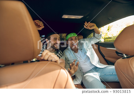 Young people feeling carefree and having fun in the car Young people feeling carefree and having fun in the car 93013815