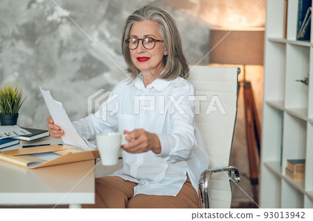 Well-dressed and good-looking businesswoman in the office Well-dressed and good-looking businesswoman in the office 93013942
