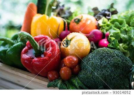 Crate filled with a large selection of healthy fresh organic fruits and vegetables shot on dark wooden table. 93014052