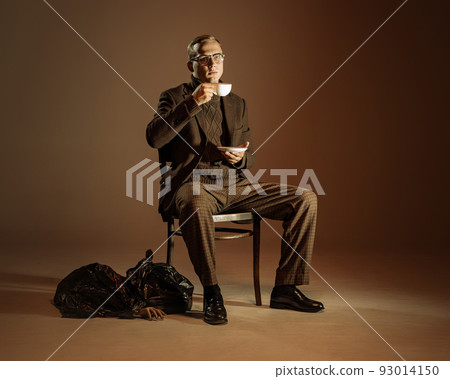 Retro style portrait of young man, writer and traveler wearing vintage style clothes isolated over dark brown background. Business, art, fashion concept 93014150