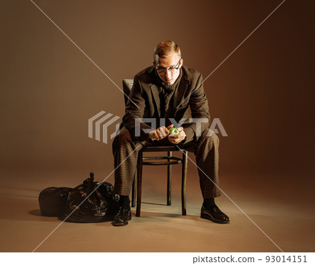 Retro style portrait of young man, writer and traveler wearing vintage style clothes isolated over dark brown background. Business, art, fashion concept 93014151